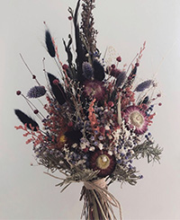 native flower bouquet with touches of dark colours, burgundy and red, wrapped in twine